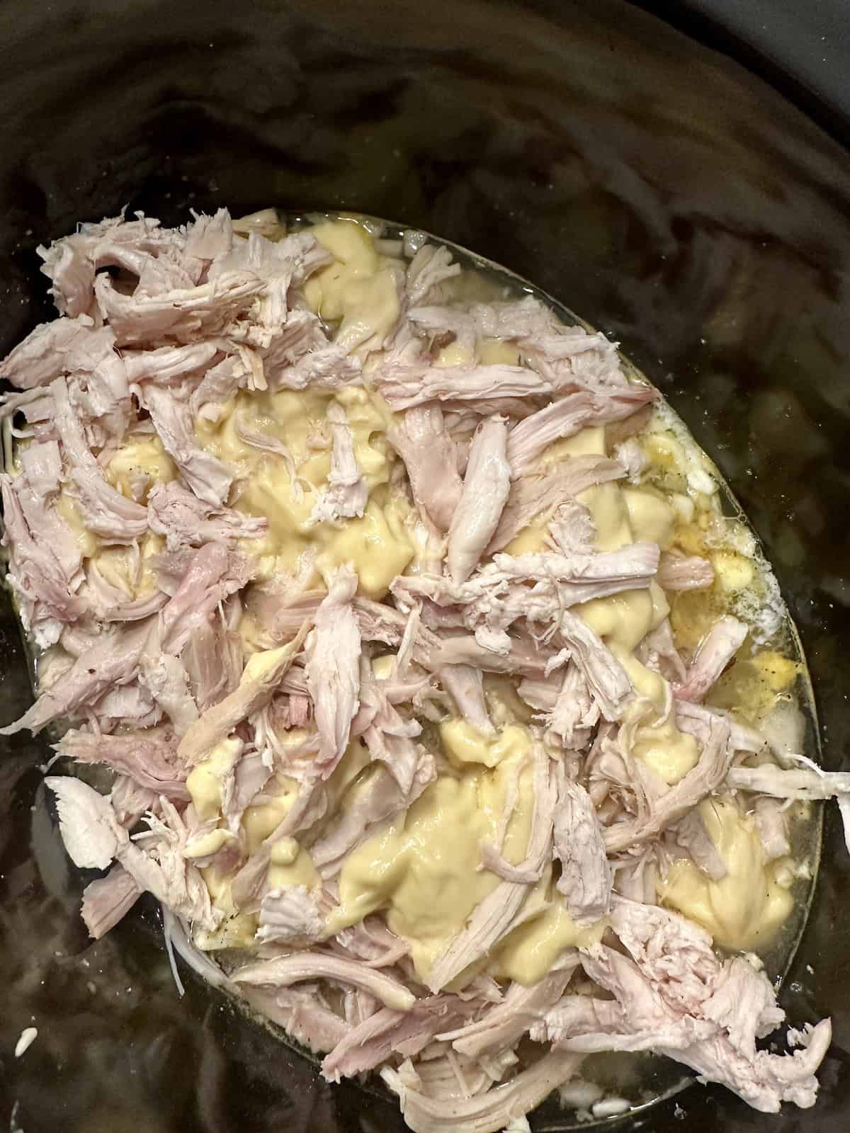 rotisserie chicken and cream of chicken soup with rice in a crockpot