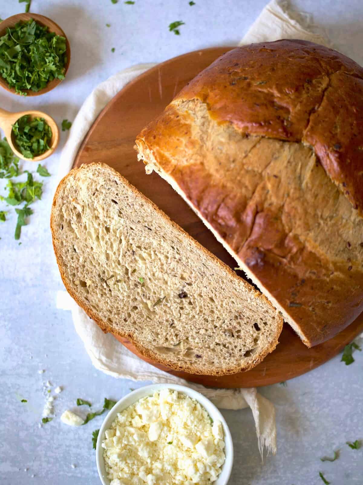 sliced bread machine olive bread on a wooden board