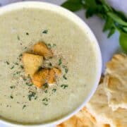 slow cooker cream of broccoli soup in a white bowl