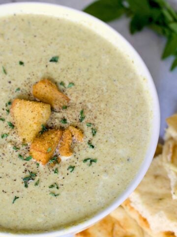 slow cooker cream of broccoli soup in a white bowl