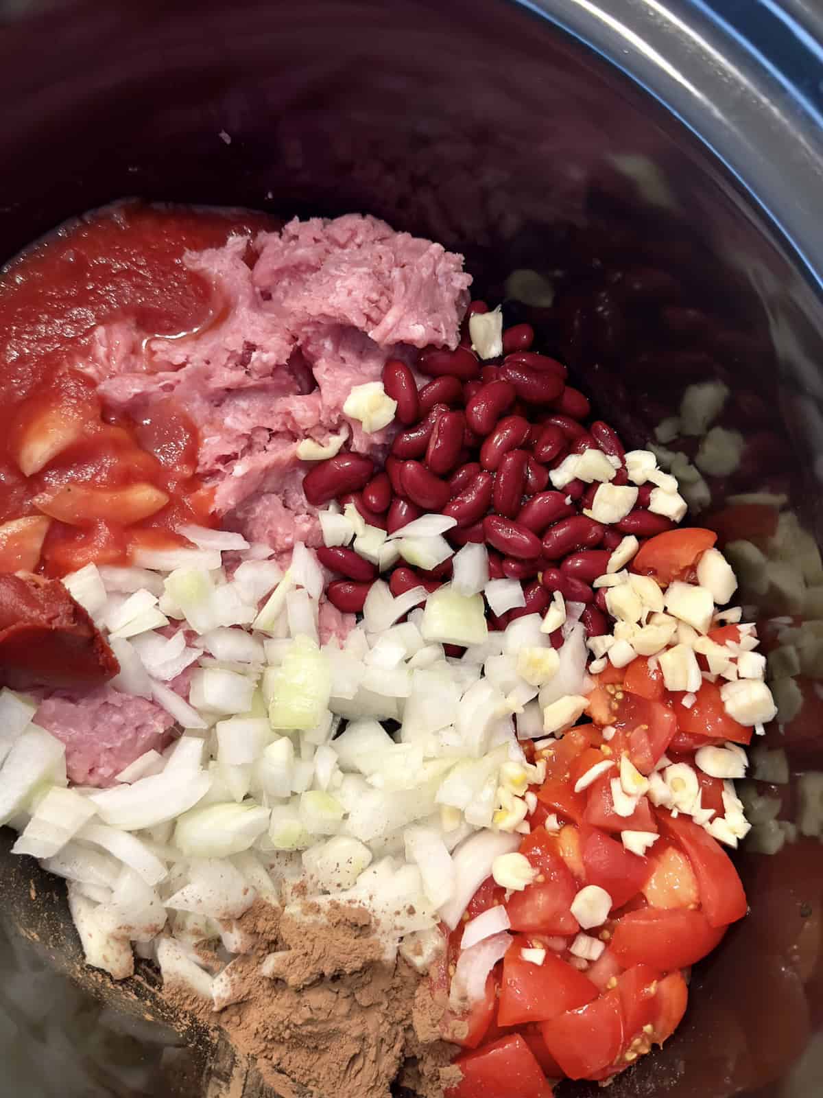 uncooked ingredients for chili in a crockpot