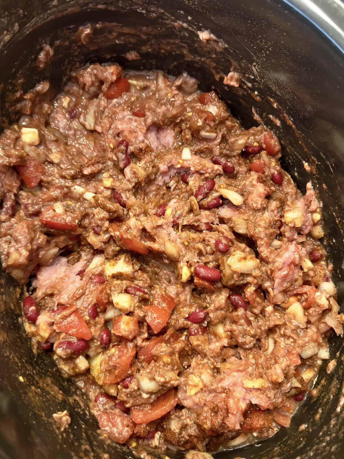 uncooked turkey chili ingredients in a slow cooker