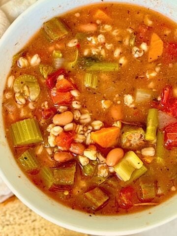 pressure cooker vegetable farro soup in a white bowl