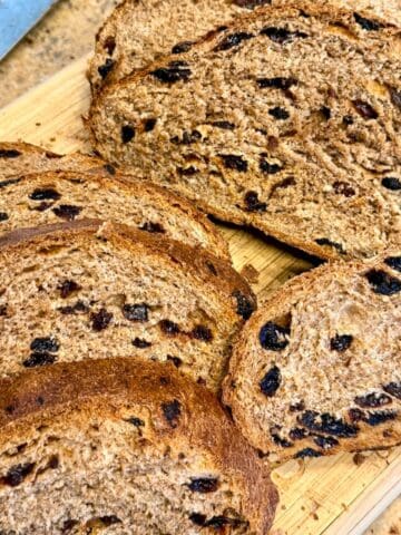 whole wheat cinnamon raisin bread sliced on a cutting board