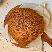 flaxseed bread machine bread sliced on a wooden serving board