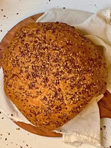 flaxseed bread machine bread sliced on a wooden serving board