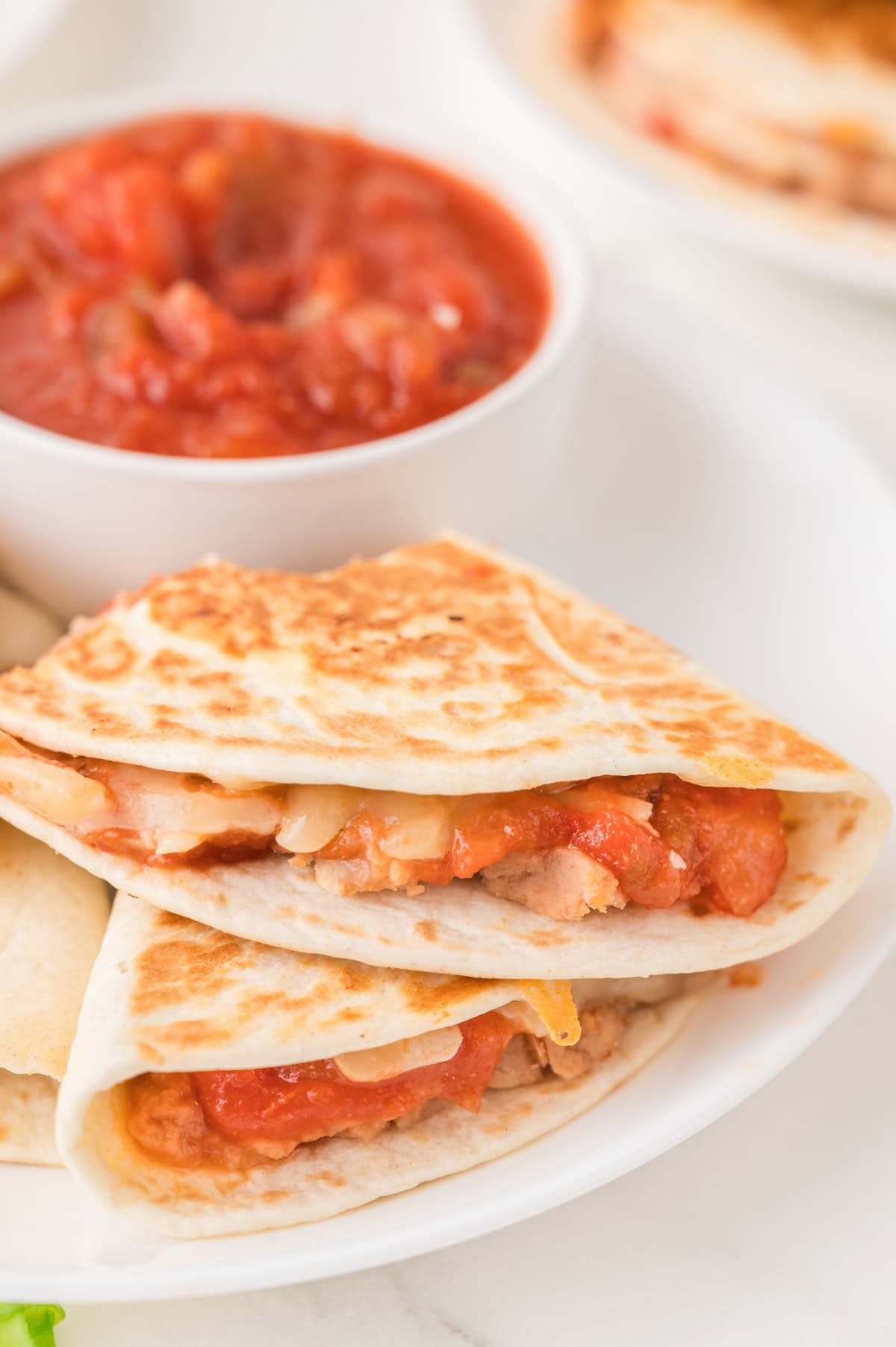 cheese and bean quesadilla sliced on a plate