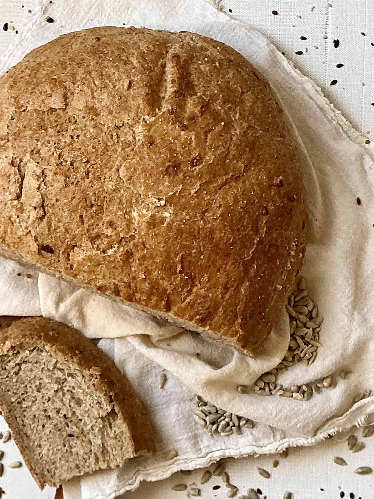 bread machine sunflower seed bread sliced on a cutting board