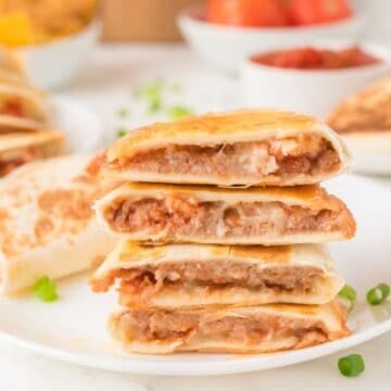 cheese and bean quesadilla slices in a stack on a plate
