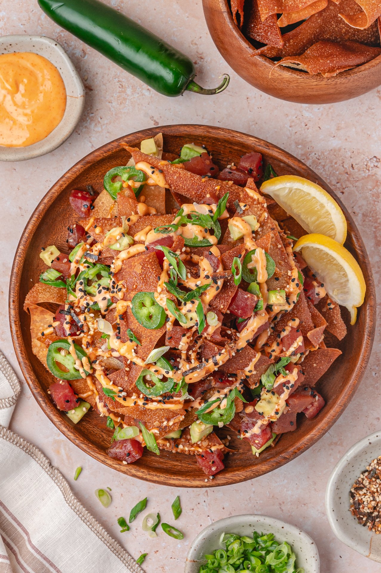 tuna poke nachos in a plate with toppings