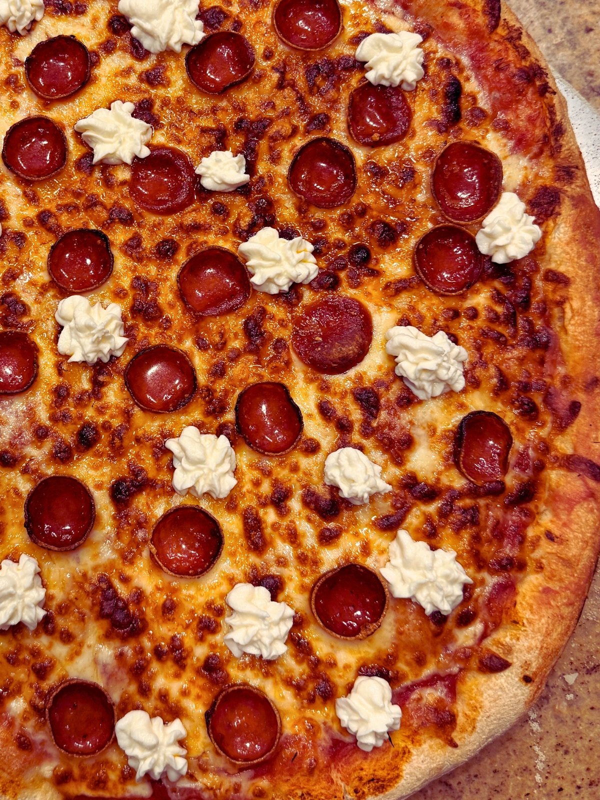 hot honey pepperoni pizza on a pizza peel