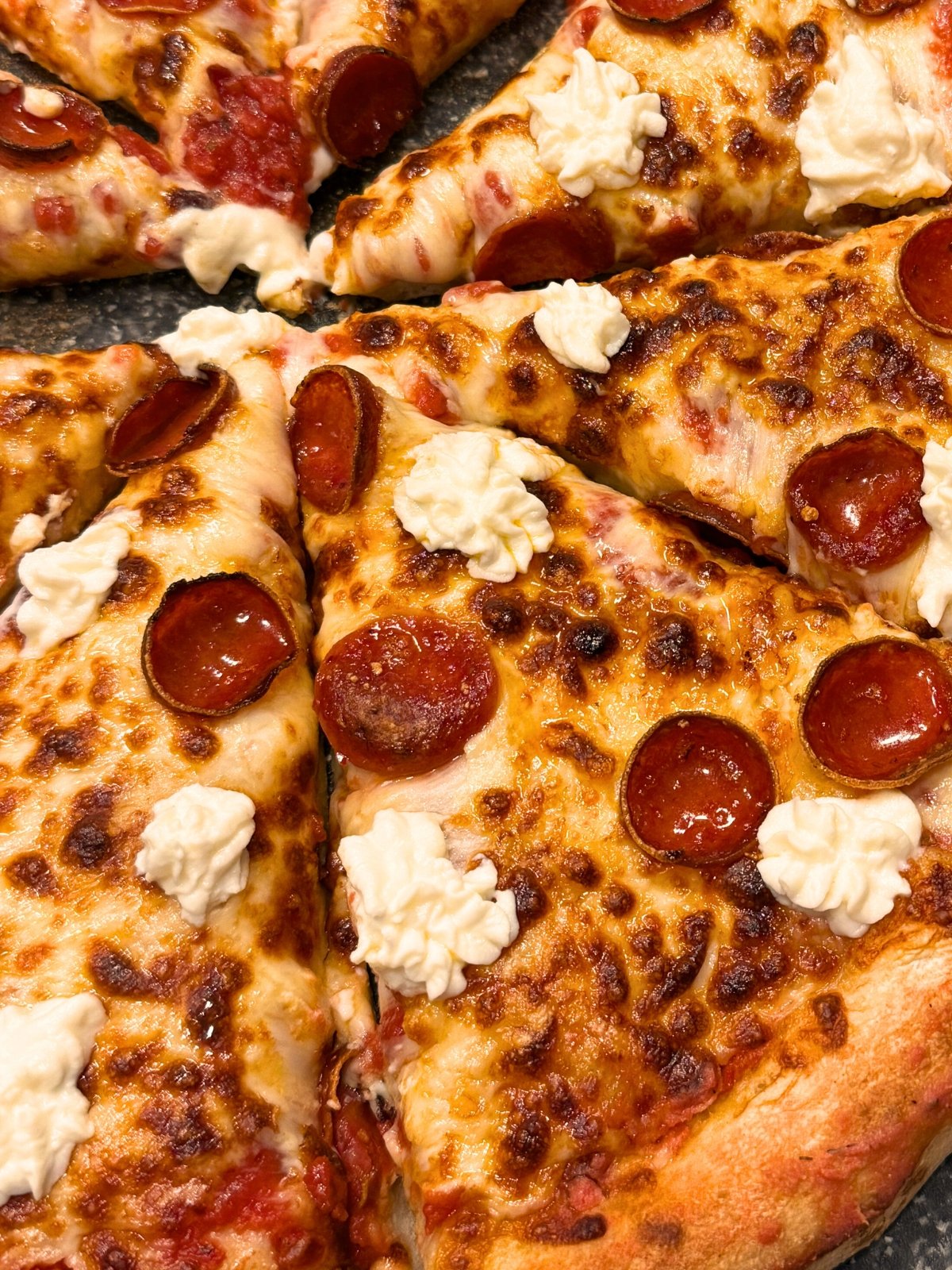slices of hot honey pepperoni ricotta pizza