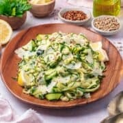 raw zucchini salad on a brown plate