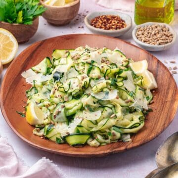 raw zucchini salad on a brown plate