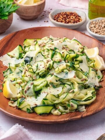 raw zucchini salad on a brown plate