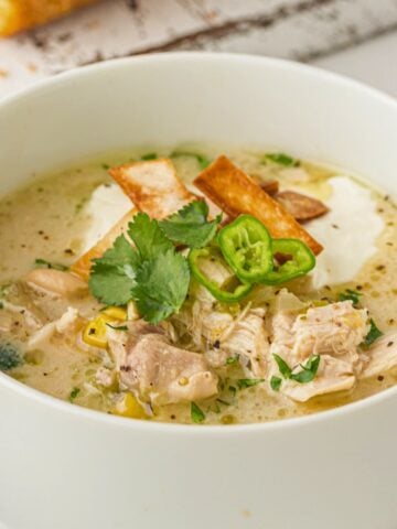 white chicken chili in a bowl with toppings