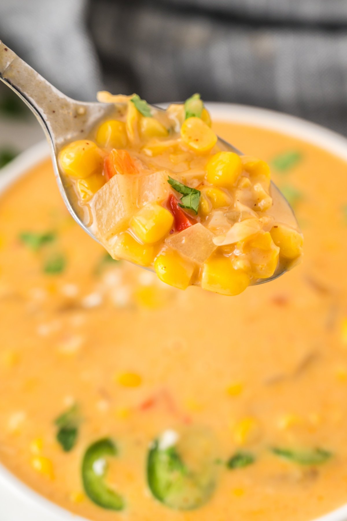 close up of mexican street corn soup on a spoon