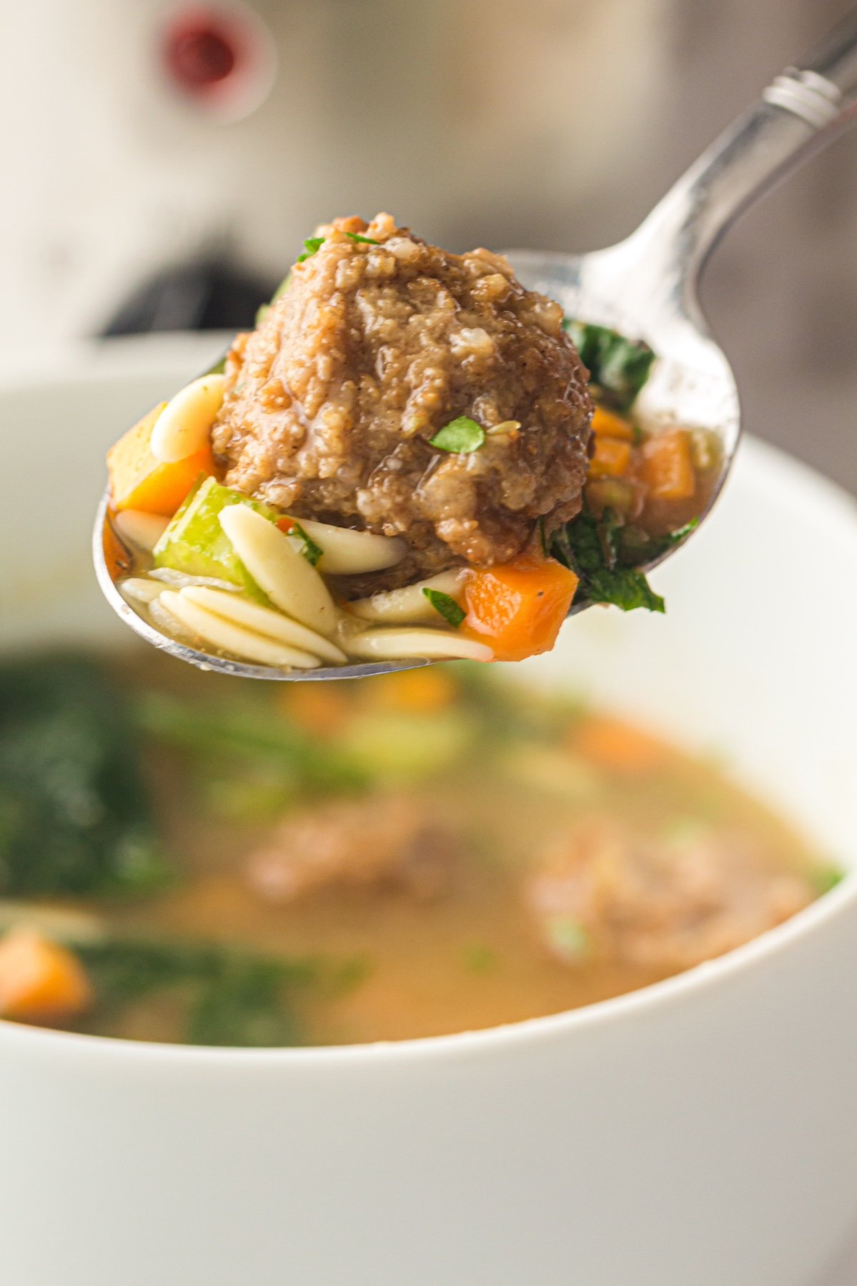close up of a meatball on a spoon