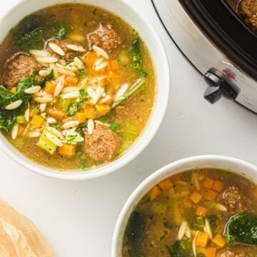 italian wedding soup in 2 white bowls