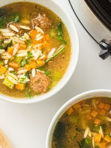 italian wedding soup in 2 white bowls