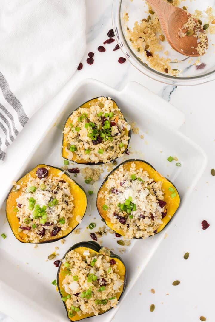 stuffed acorn squash on a white serving tray