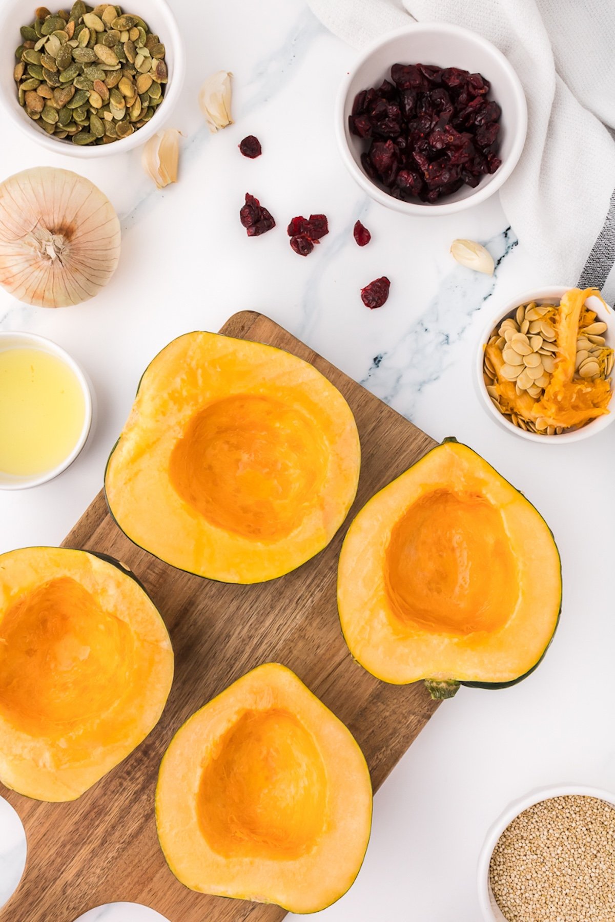 acorn squash sliced into halves with the insides scooped out