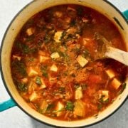 spicy tofu soup in a blue dutch oven