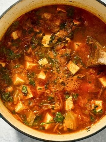 spicy tofu soup in a blue dutch oven
