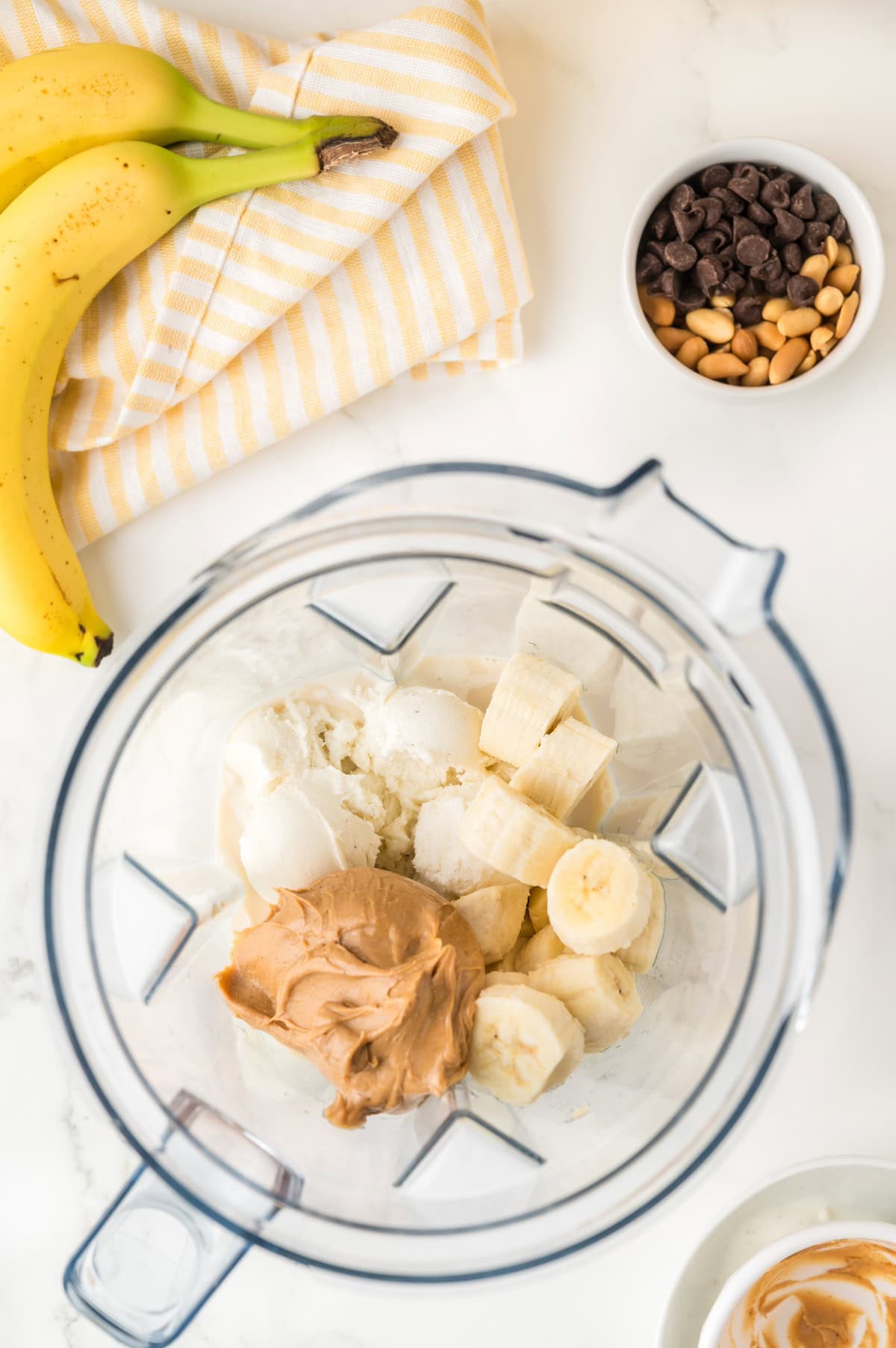ice cream, peanut butter, and milk in a blender overhead shot