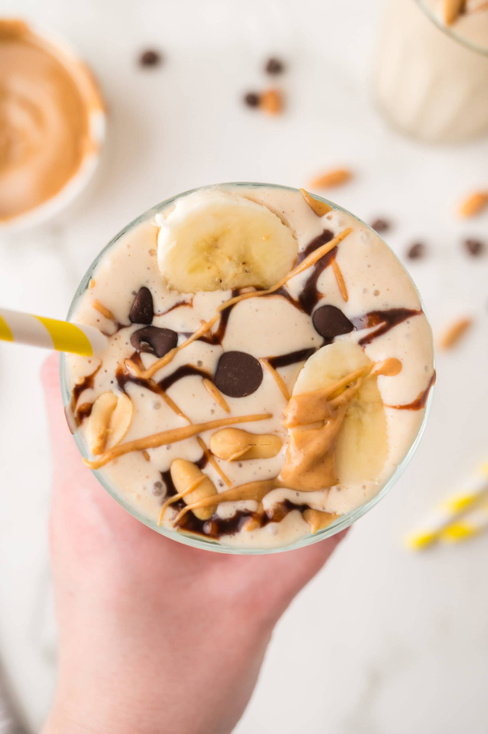 top shot of peanut butter banana milkshake in a glass