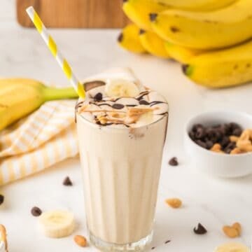 peanut butter banana milkshake topped with chocolate in a glass cup
