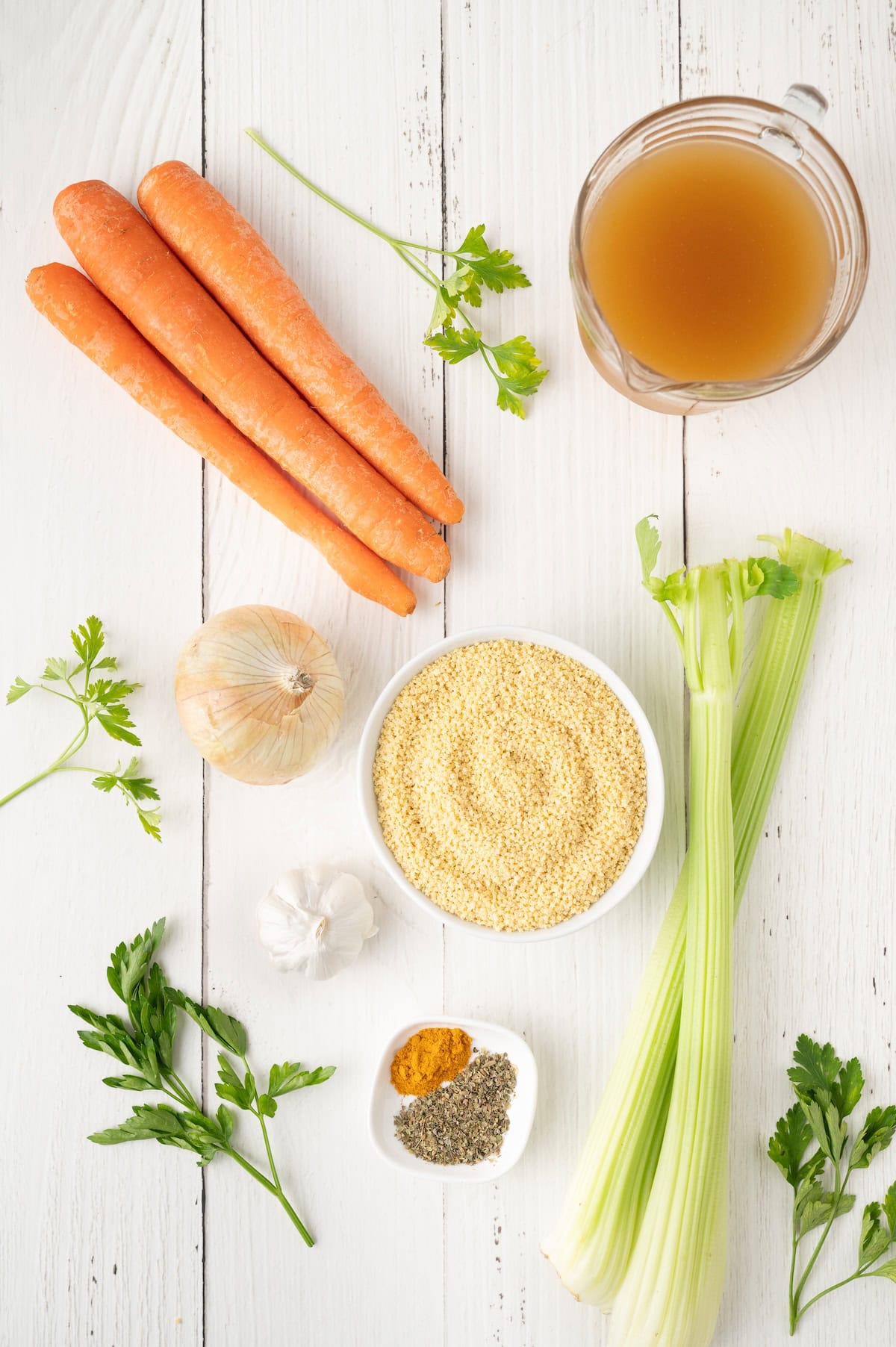 carrots, celery, broth and seasonings on a counte