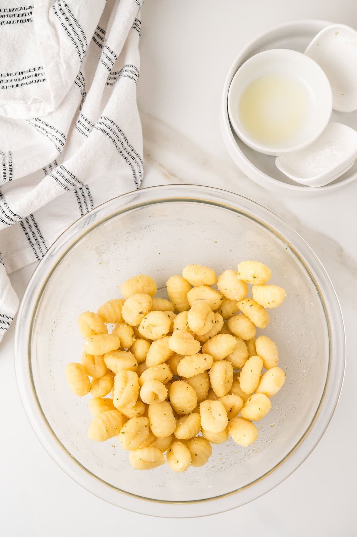 gnocchi tossed with olive oil in a bowl
