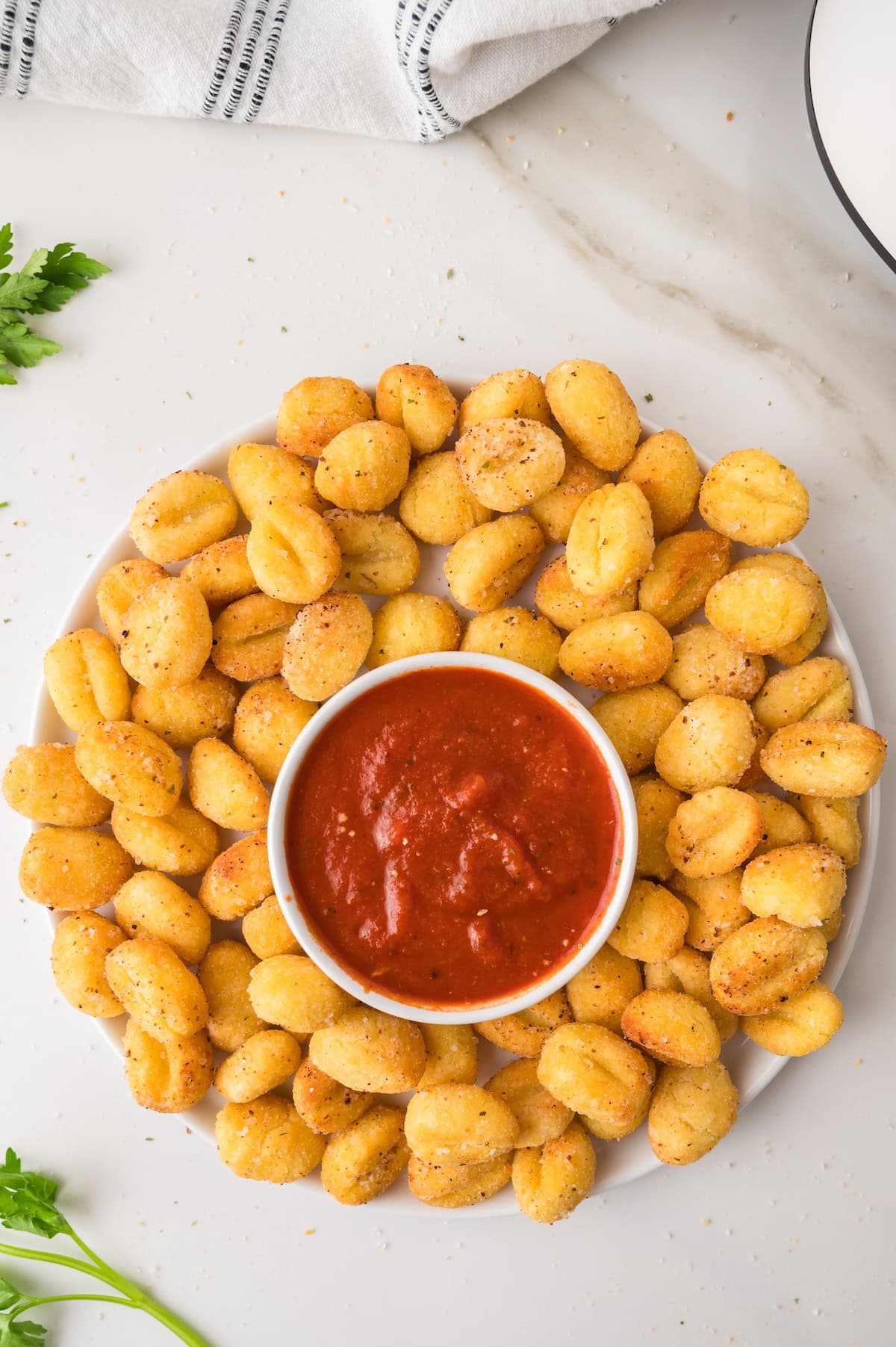 air fryer gnocchi on a plate with marinara dipping sauce
