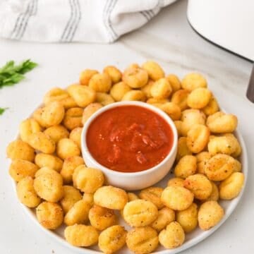 air fried gnocchi in a plate with marinara sauce