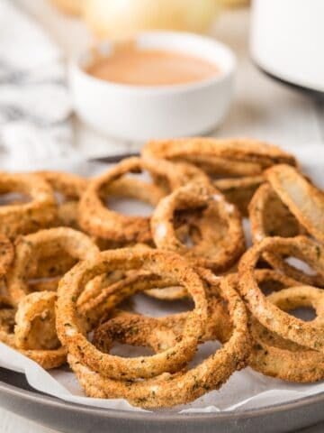 air fryer onion rings on a white platter