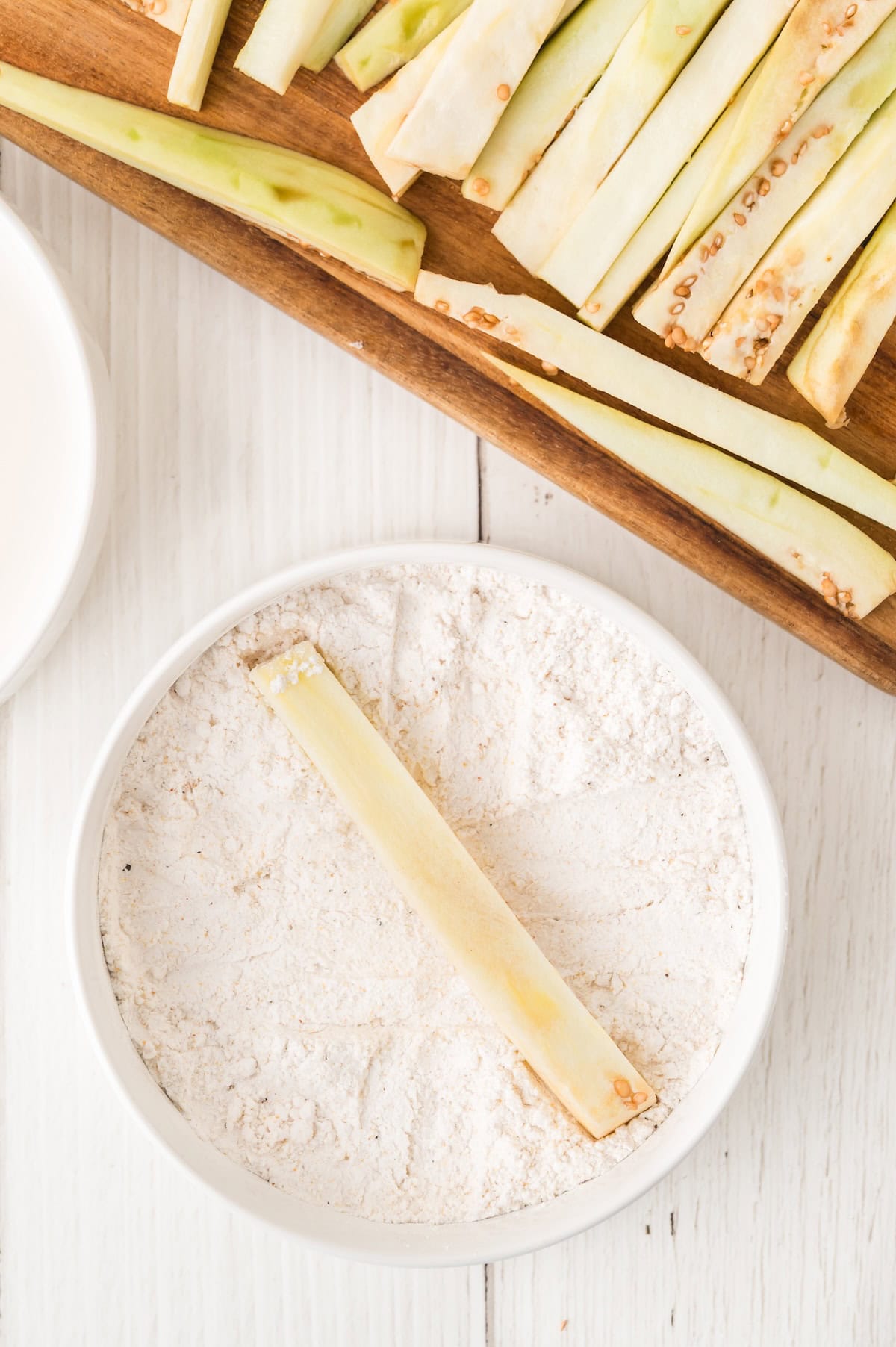 sliced eggplant in a blow of flour