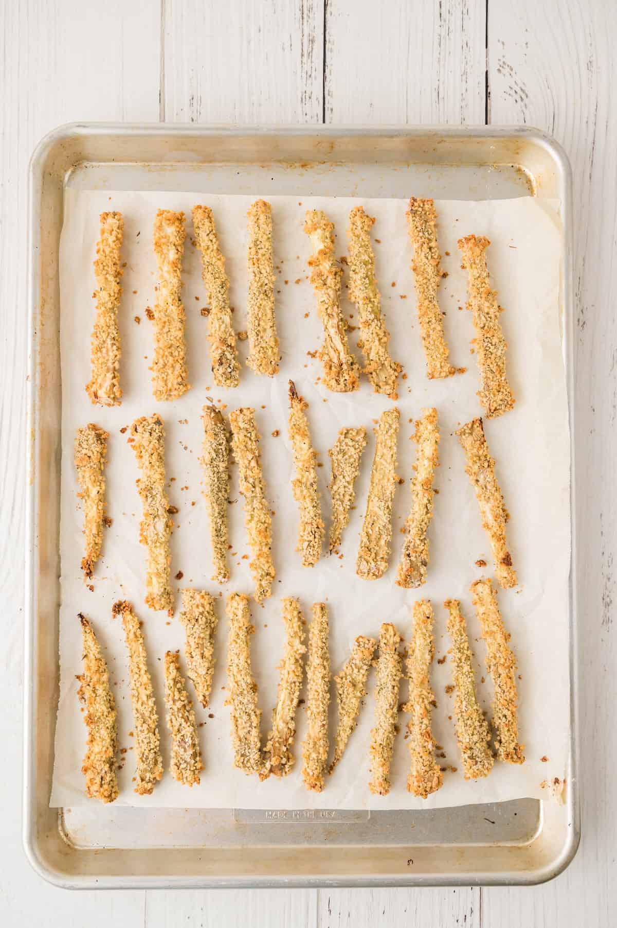 unbaked eggplant fries on a baking sheet