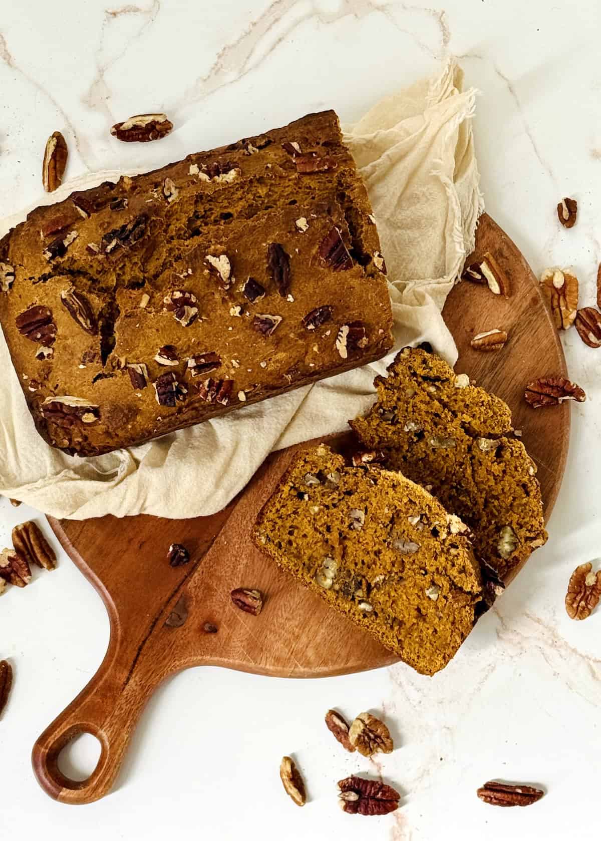 pumpkin pecan bread on a cutting board