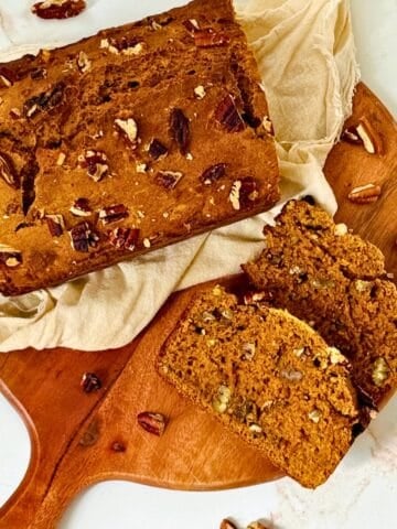 pumpkin pecan bread sliced on a cutting board