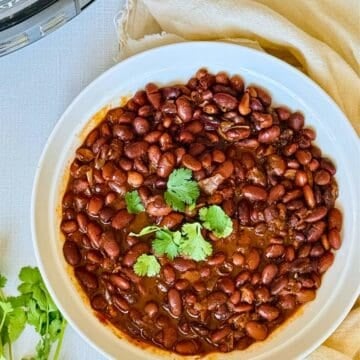 slow cooker pinto beans in a white bowl