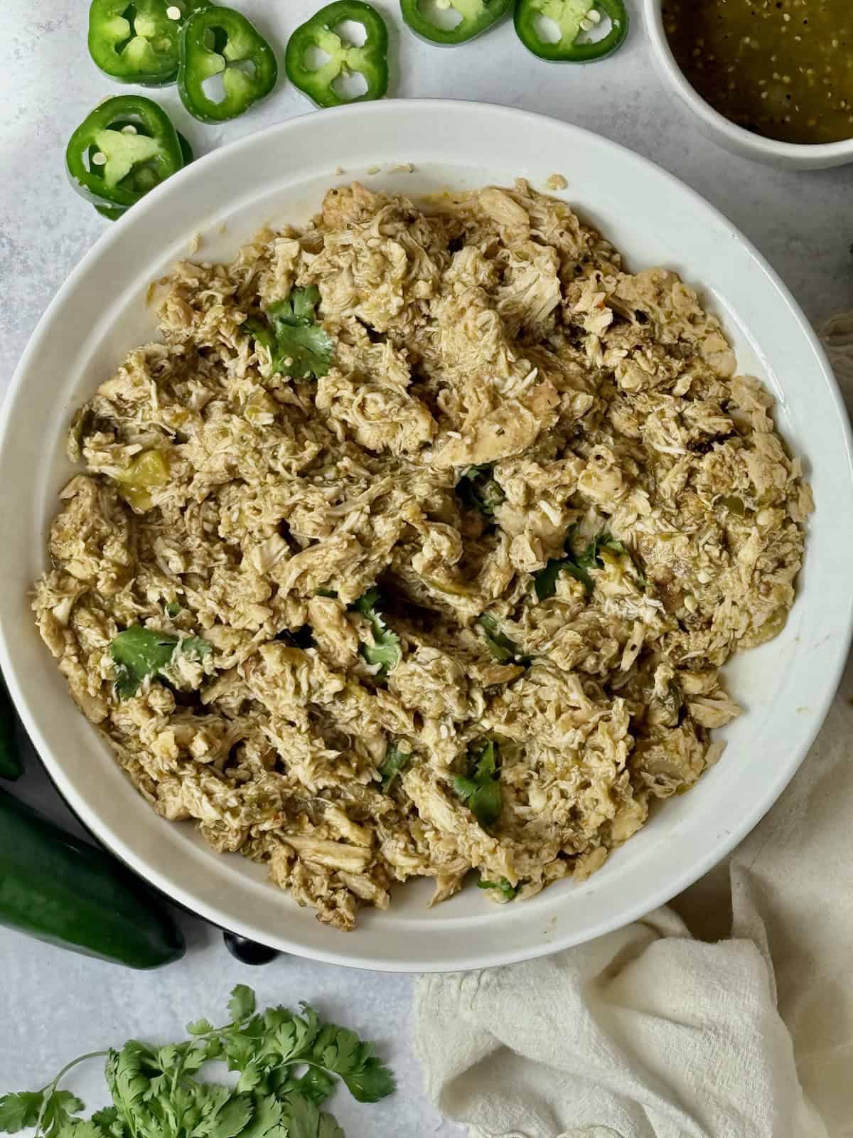 shredded salsa verde chicken in a bowl