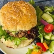 black bean burger on a hamburger bun with salad
