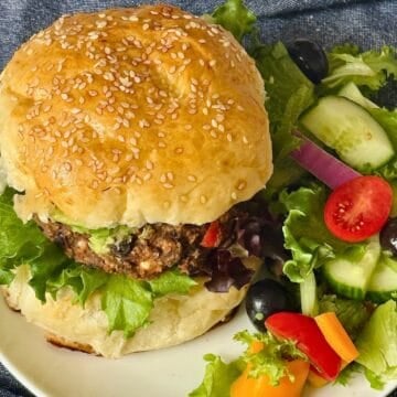 black bean burger on a hamburger bun with salad