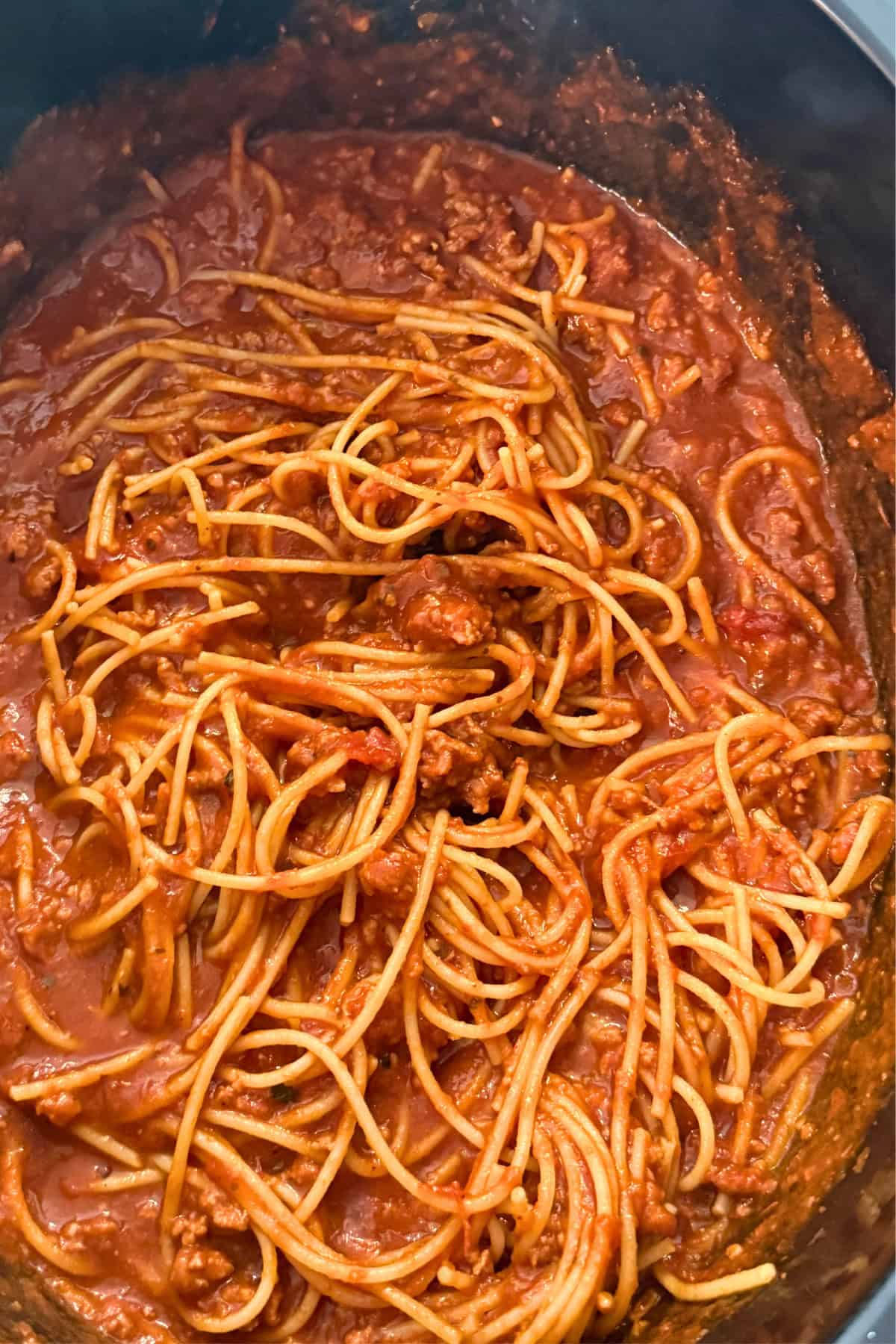spaghetti and meat sauce in a crockpot with ground beef