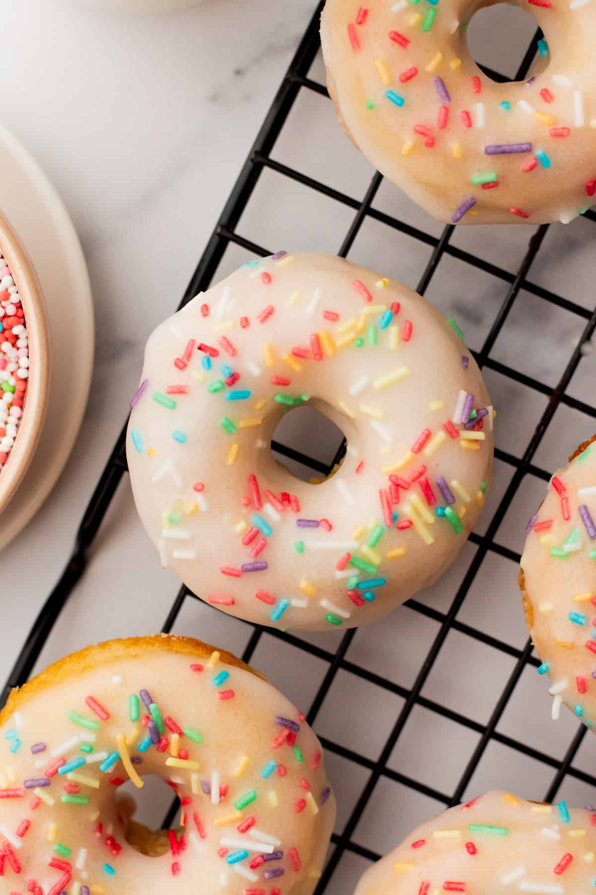 baked vanilla donuts on a cooling rack