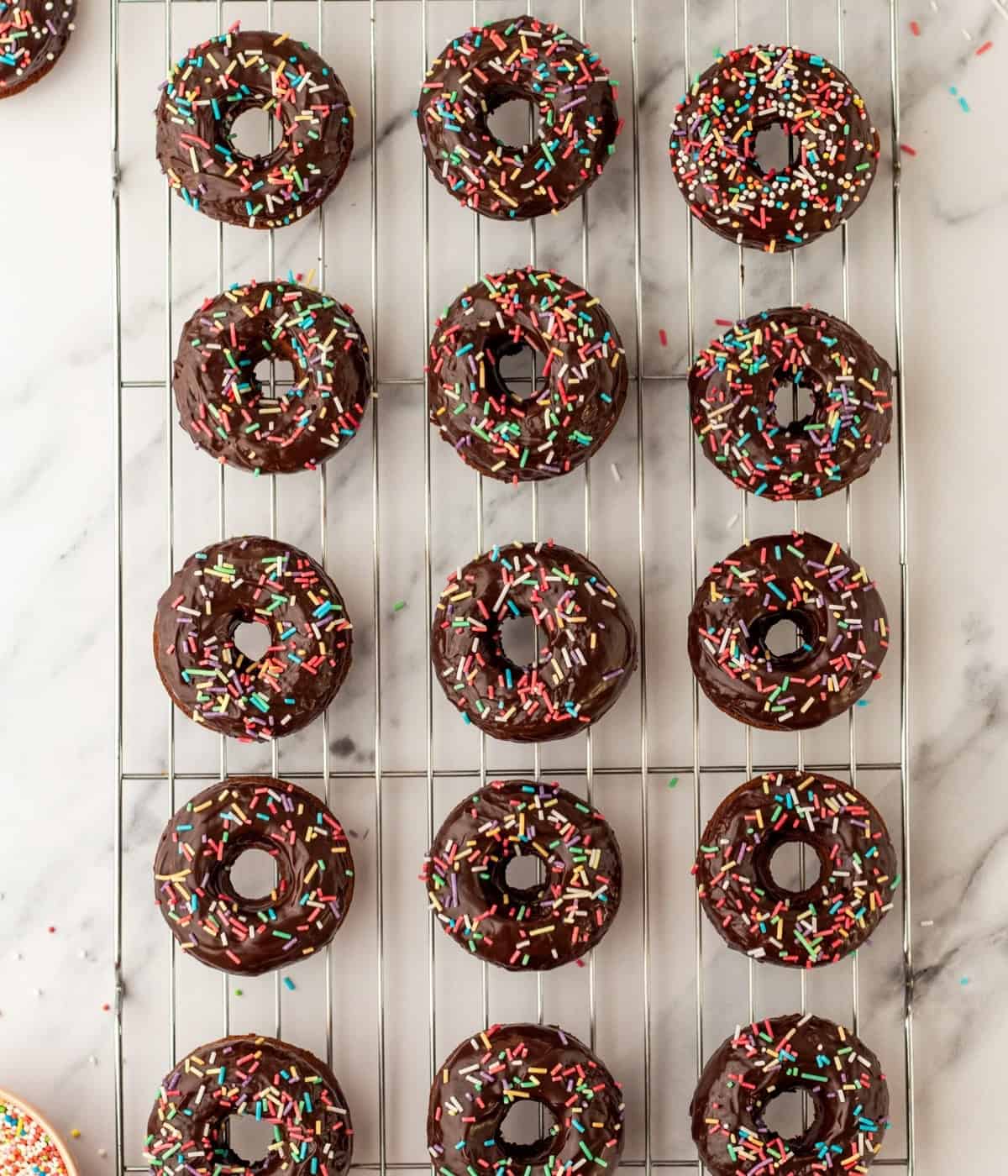 baked chocolate donuts on a cooling rack