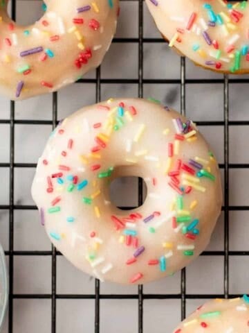 baked vanilla donuts on a cooling rack