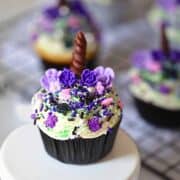 Halloween unicorn cupcakes on a white stand
