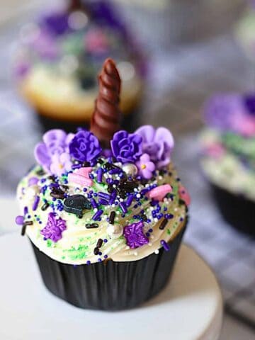 Halloween unicorn cupcakes on a white stand